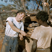 David Smith paying Aborigines for collecting sandalwood at Cundeelee, May 1957